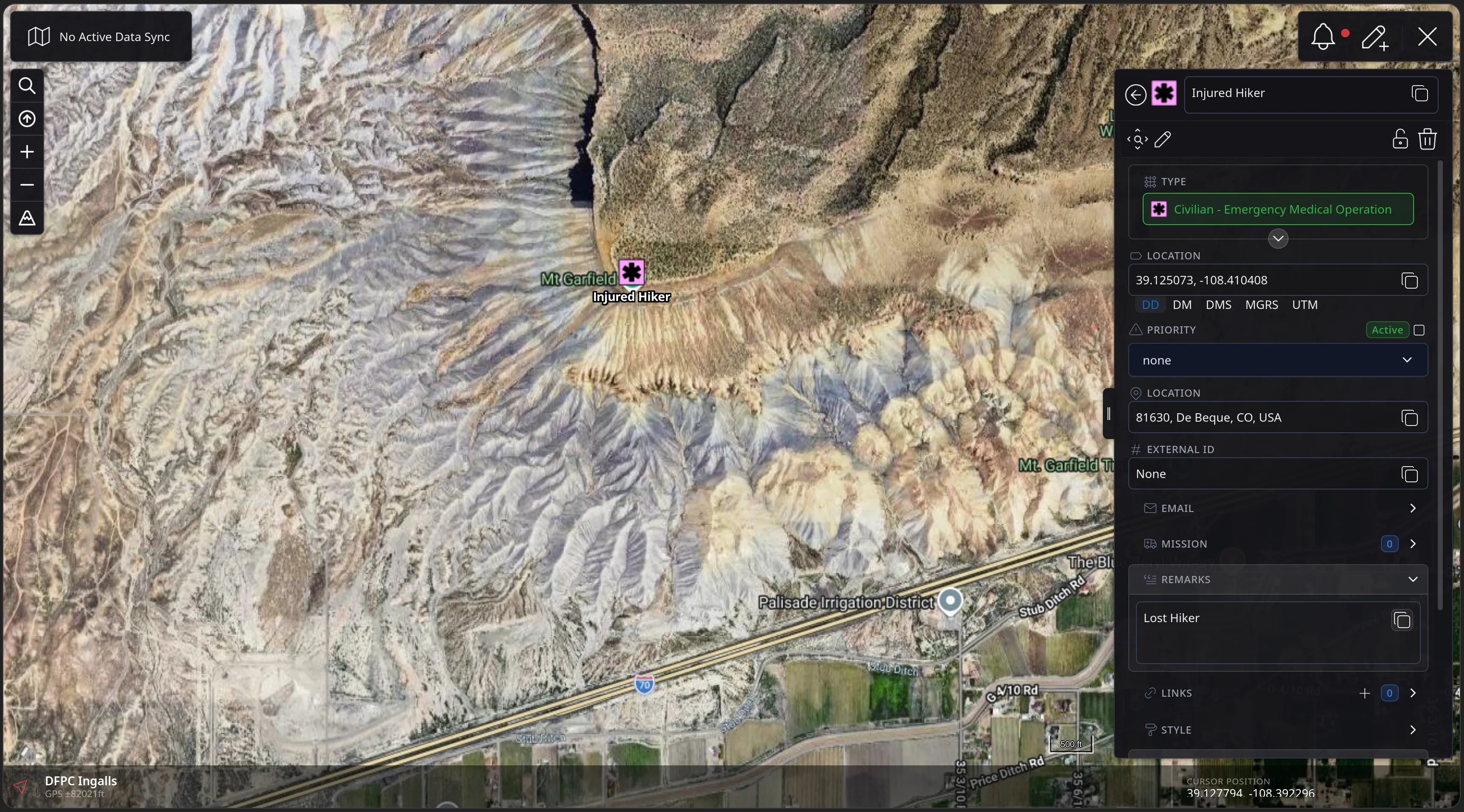 The created Injured Hiker event drawn on the map below Mt Garfield with its pink medical symbol, and its detail panel showing the type, an Active priority toggle, the location, an External ID row, and the Lost Hiker remarks.