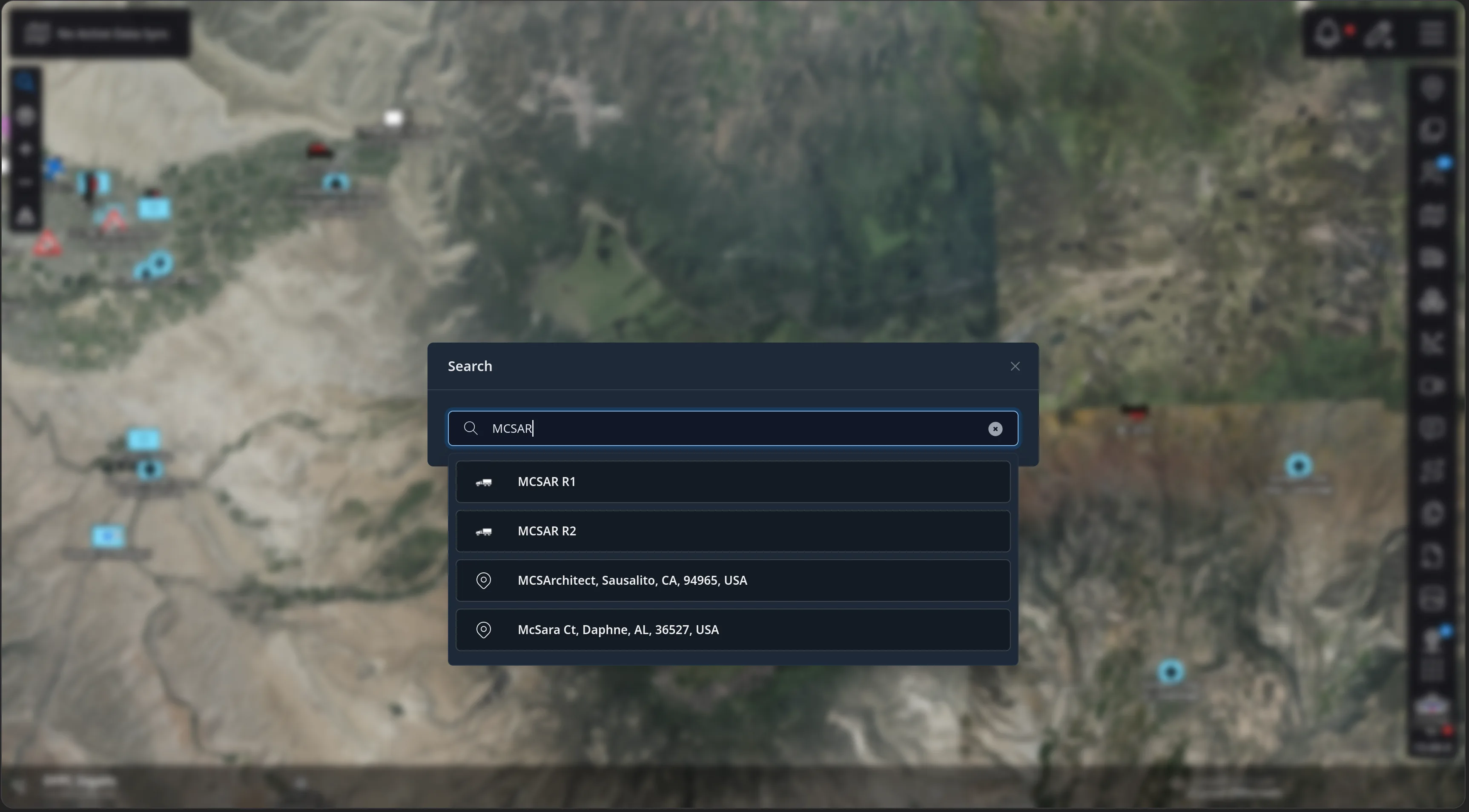 The CloudTAK map with a Search dialog open over it, the query MCSAR typed in, and four results below: the callsigns MCSAR R1 and MCSAR R2 with vehicle icons, and two geocoded addresses, MCSArchitect in Sausalito, CA and McSara Ct in Daphne, AL.